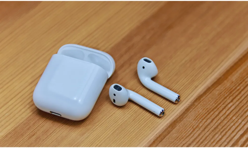 Close-up of a white AirPods charging case showing the USB-C port and speaker holes.