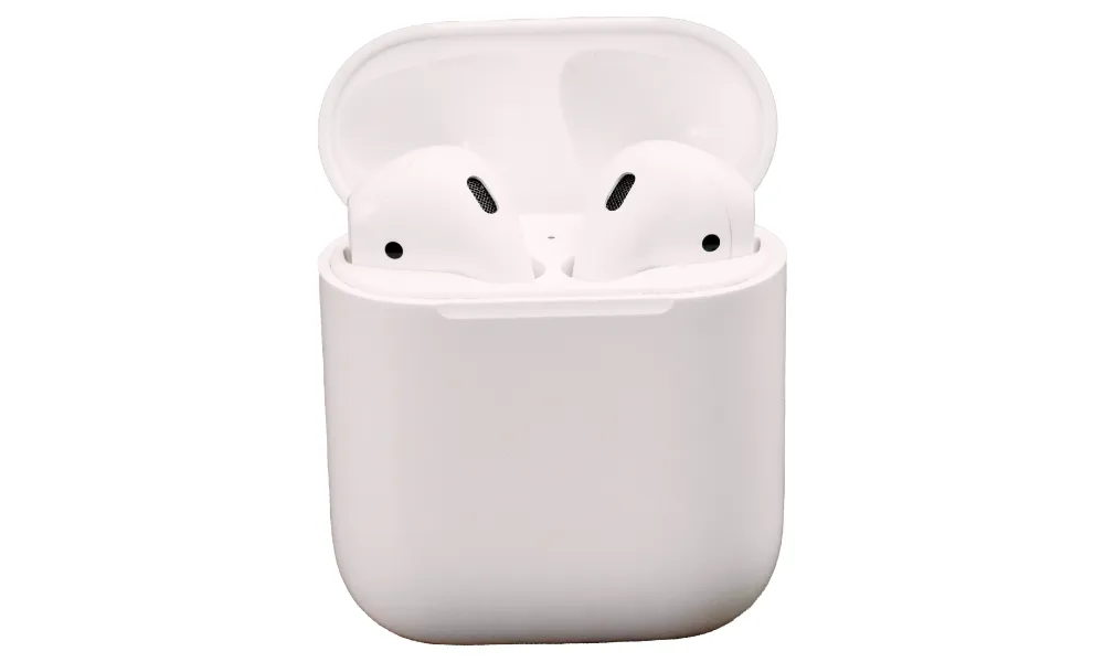Close-up of a white AirPods charging case showing the USB-C port and speaker holes.
