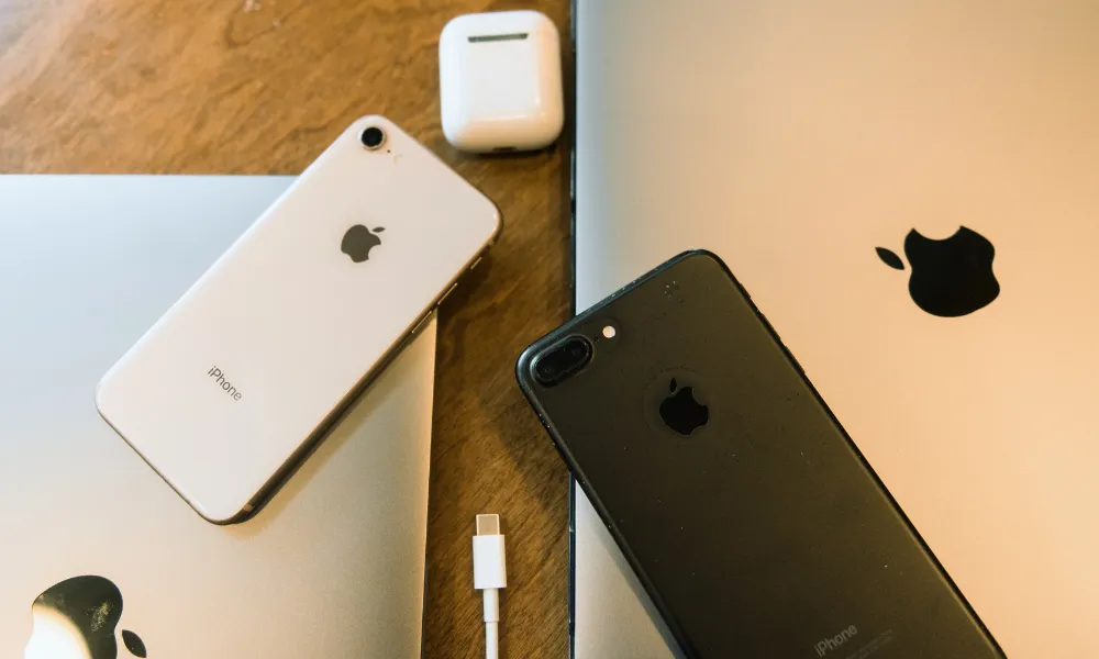 Close-up of a white AirPods charging case showing the USB-C port and speaker holes.